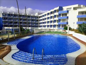 a swimming pool in front of a building at Refurbished 1 bedroom apartment with large pool - GP202 in San Miguel de Abona