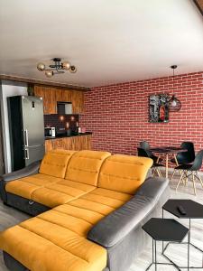 a living room with a couch and a brick wall at Room1402 in Odesa