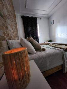 a room with two beds and a couch in it at FamilyConfort Saidia in Saïdia
