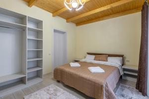 a bedroom with a bed and a book shelf at Шепіт Лісу in Bukovel