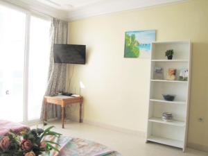 a bedroom with a bed and a desk and a window at Taghazout Waves 1 in Taghazout