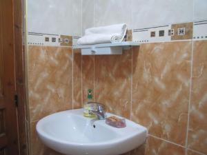 a bathroom with a sink and a towel on a shelf at Taghazout Waves 1 in Taghazout