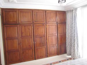 a wall of wooden cabinets in a bedroom at Taghazout Waves 1 in Taghazout
