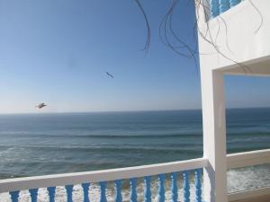 a view of the ocean with a plane flying over it at Taghazout Waves 1 in Taghazout