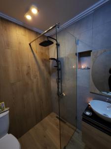 a bathroom with a shower and a toilet and a sink at FamilyConfort Saidia in Saïdia