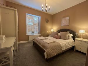 a bedroom with a large bed and a window at 20 Lisburn Street in Alnwick