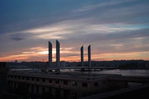 a view of a building with a sunset in the background at Seeko'o Hotel Bordeaux in Bordeaux
