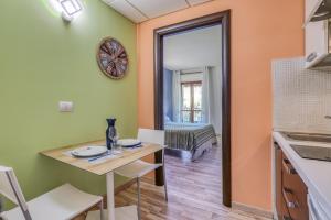 a kitchen and dining room with a table and chairs at Asso Residence in Terni +14 photos