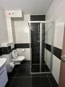a bathroom with a shower and a toilet at BASELINE športový areál & penzión in Banská Bystrica