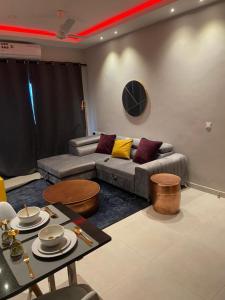 a living room with a couch and a table at Aminah’s Space - Jobz Luxury Rental in Bijilo