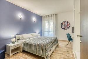 um quarto com uma cama e uma parede azul em Asso Residence em Terni