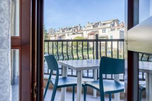 a table and chairs on a balcony with a view of a building at Asso Residence in Terni