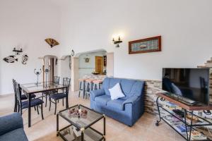 a living room with a blue couch and a table at Luminoso chalet in Alcudia