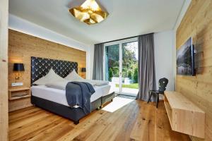 a bedroom with a bed and a large window at Parkresidenz in Garmisch-Partenkirchen