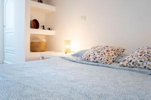 a bedroom with a blue bed with two pillows at Casa d’autore siciliana in Milan