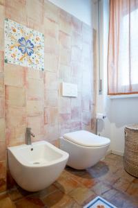 a bathroom with a white toilet and a sink at Casa d’autore siciliana in Milan