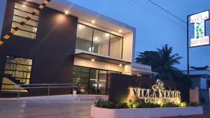 a building with a sign in front of it at Villa Verde Guest House in General Santos