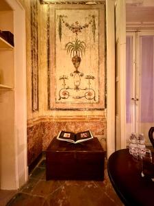 a table with a book on it in a room at Casa Santangelo Suites in Salerno