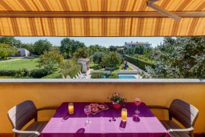 Balkón nebo terasa v ubytování VILLA LIVIA with three nice apartments, swimming pool, childrens playground, barbecue and free parking