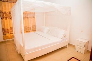 מיטה או מיטות בחדר ב-Leisure Safaris and Inns