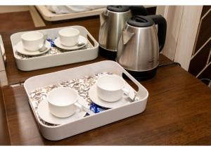 a tray with cups and saucers on a table at Ritumbhara Hotel & Resort in Alwar