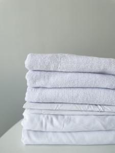 a stack of white towels stacked on top of each other at Premium Apartments Esil Riverside in Astana