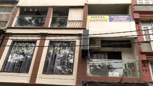 a building with a hotel sign on the side of it at Hotel Darpan By WB Inn in Jammu