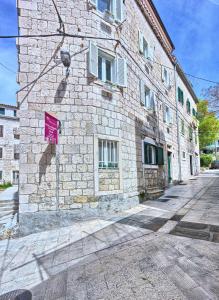 a brick building with a sign on the side of it at Under Constructiion in Split