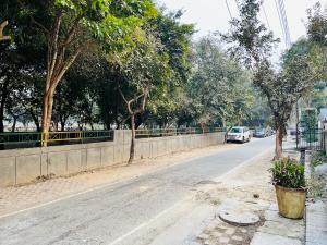 a car parked on the side of a road at Abode Residency Safdarjung Enclave Near US Embassy Delhi in New Delhi