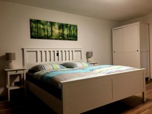 a bedroom with a bed and a painting on the wall at Haus Allgäu Ruh in Görisried