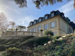 a large house on a hill with a fence at Grand appart 150m2 dans belle maison bourgeoise in Vernaison