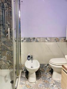 a bathroom with a toilet and a sink at Blue House in Alghero