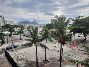 a group of palm trees on a city street at Apto 5 quartos na Orla de Copacabana in Rio de Janeiro