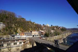 vista para uma ponte sobre um rio com edifícios em imperator 1 Hotel em Kutaisi