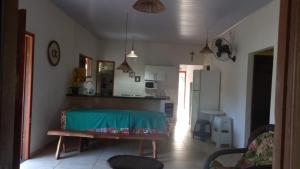 a kitchen with a table in the middle of a room at Casa na Praia de Saquaira - Península de Maraú. in Marau