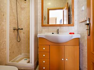 a bathroom with a sink and a shower and a tub at Alameda Apartment in Faro