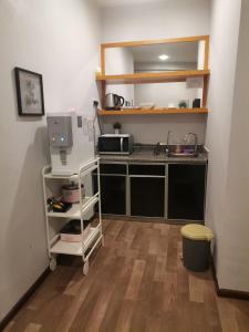 a kitchen with a counter with a sink and a microwave at Dzulstudio(Muslim) Nova Highland in Brinchang