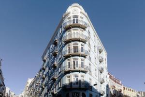 a blue building with balconies on the side of it at Apartamento Andrade in Lisbon