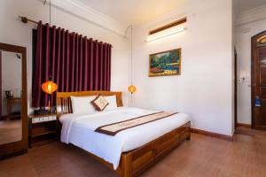 Postel nebo postele na pokoji v ubytování Hoa My II Hotel