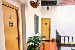 a hallway with two yellow doors and a table at Milagros Central Apartments in El Puerto de Santa María