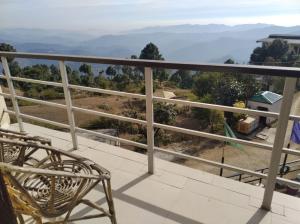 a balcony with a view of the mountains at Flutter Hotels & Resorts in Lansdowne