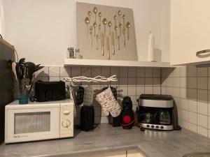 a kitchen counter with a white microwave and a counter top at Regenbogengasse in Schkeuditz