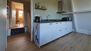 a kitchen with a sink and a counter top at B&B Kamille in Delden