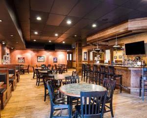 um restaurante com mesas e cadeiras e um bar em Quality Inn em Lewisburg