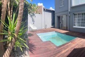 a backyard with a swimming pool on a wooden deck at Private luxurious 3 bedroom complete house in Bloemfontein