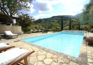 a swimming pool with a view of a mountain at Le miau in Vercoiran