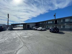 a parking lot with cars parked in front of a building at Motel 6 Hermiston OR Umatilla in Hermiston