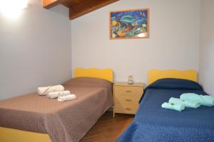 a bedroom with two beds with towels on them at B&B Alina in Catanzaro Lido