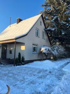 a white house with snow in front of it at Haus Hochwald in Hermeskeil