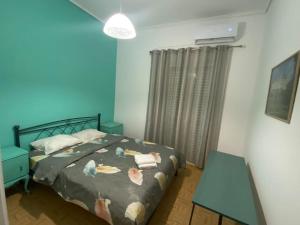 a bedroom with a bed with birds on it at Ioli Β2 apartment in Thiva